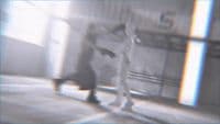 a blurry image of a person walking down a hallway