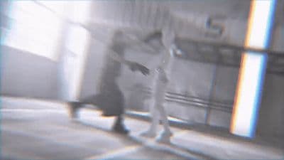 a blurry image of a person walking down a hallway