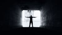 a person standing in a tunnel with their arms outstretched