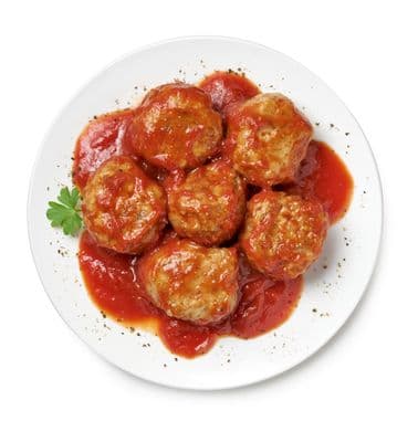 a white plate topped with meatballs covered in sauce