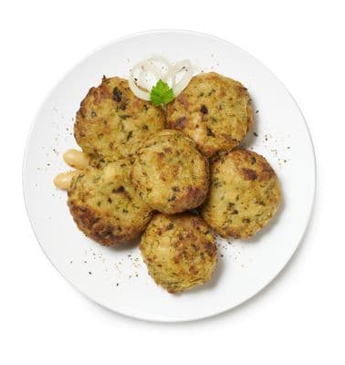 a white plate topped with crab cakes and onions