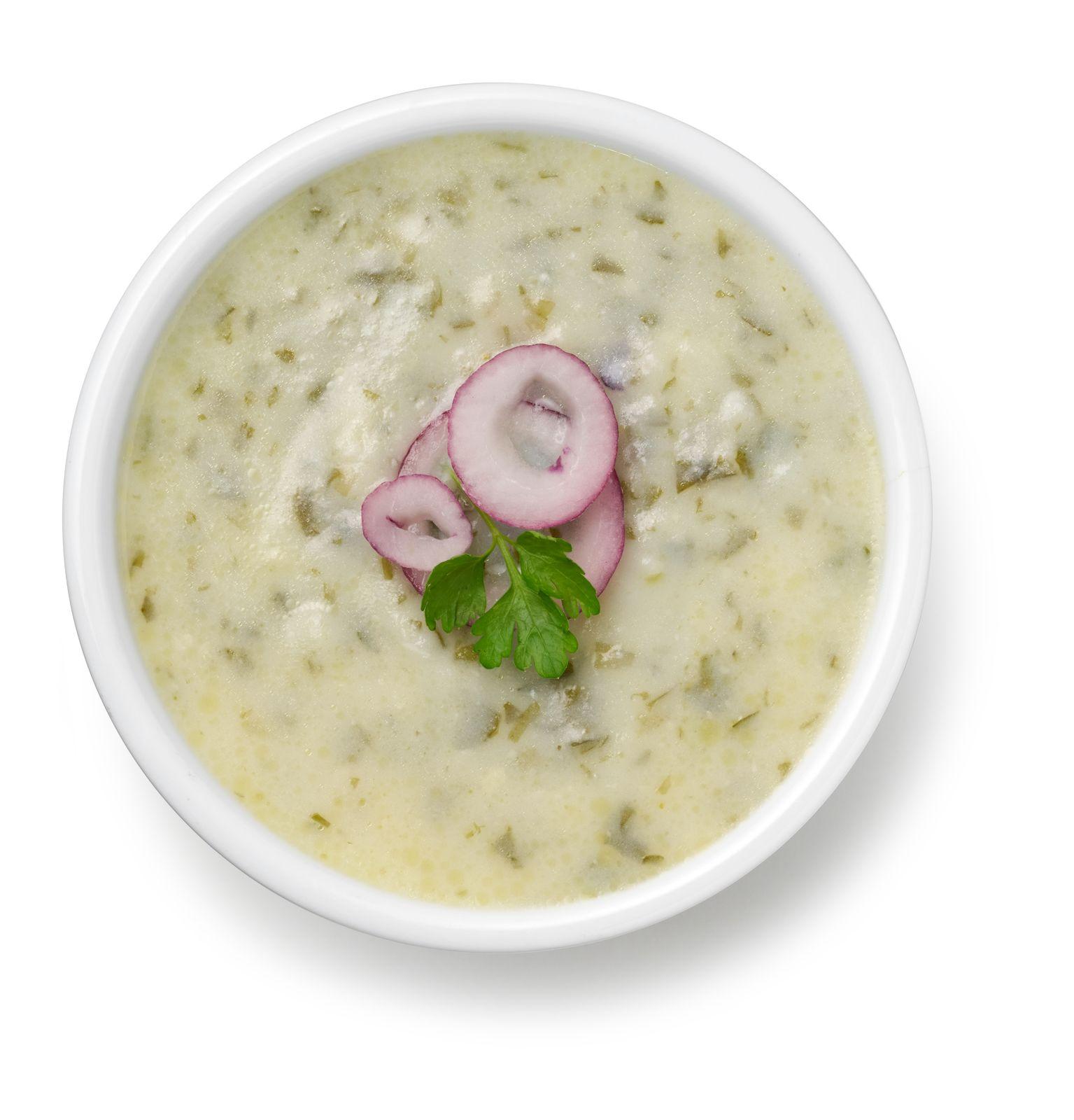 a white bowl filled with soup and vegetables