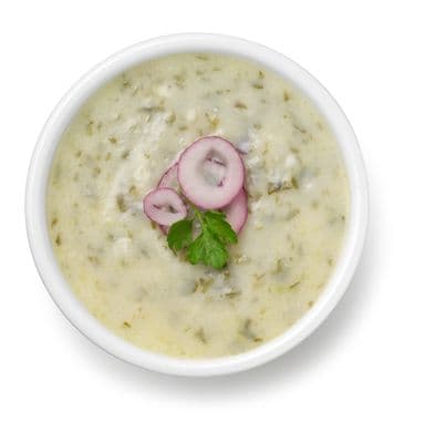 a white bowl filled with soup and vegetables