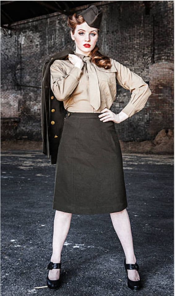 a woman in a skirt and jacket posing for a picture