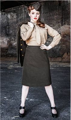 a woman in a skirt and jacket posing for a picture