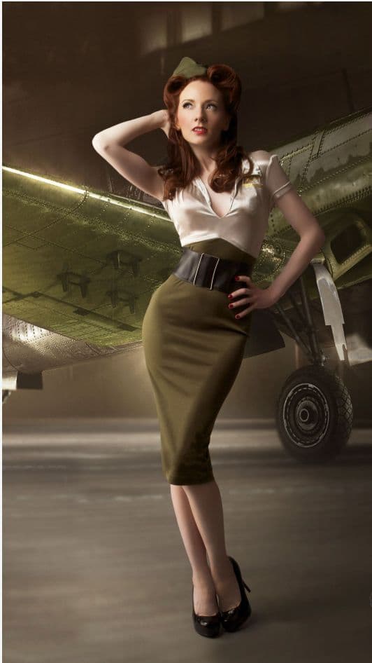 a woman standing in front of an airplane