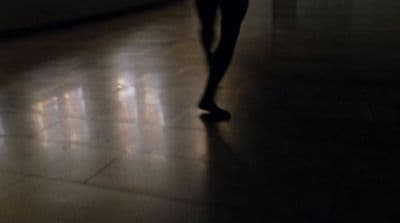 a person is walking in a dark room