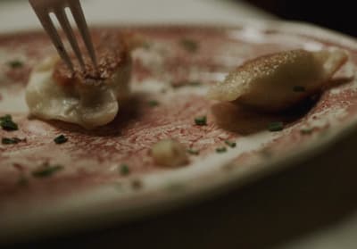 a fork sticking into a plate with food on it