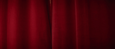 a close up of a red curtain in a room