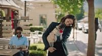 a woman holding a pug dog in her arms