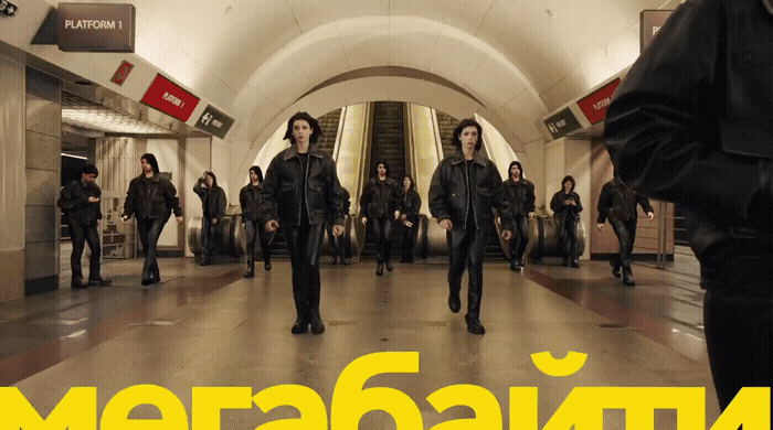 a group of people walking through a subway station