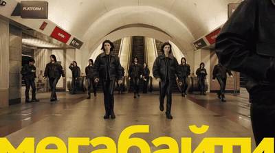 a group of people walking through a subway station
