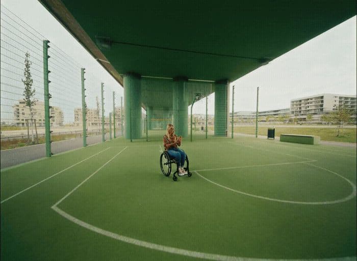 a person in a wheel chair on a tennis court