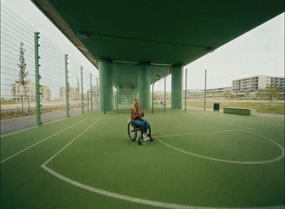 a person in a wheel chair on a tennis court