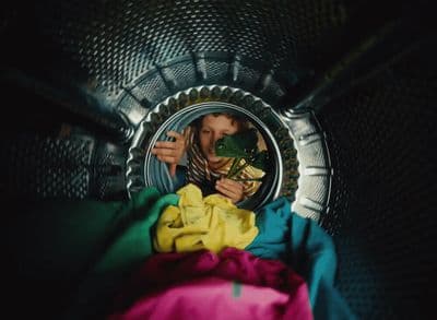 a woman looking at her reflection in a mirror