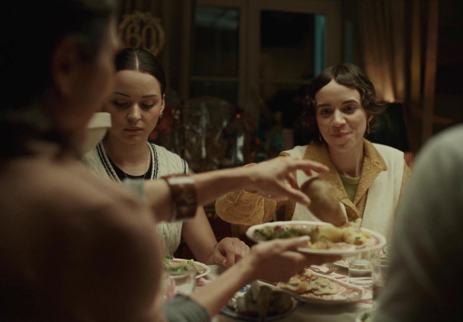 a group of people sitting around a table eating food
