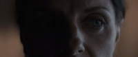 a close up of a person's face with a blurry background