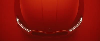 a close up of the front of a red sports car