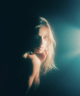 a woman is posing for a picture in the dark