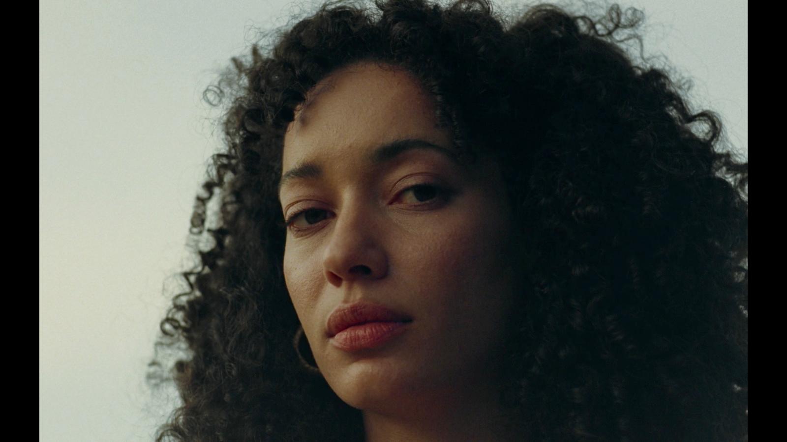 a close up of a woman with curly hair