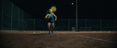 a woman is playing tennis on a tennis court