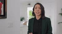 a woman in a green blazer and black shirt
