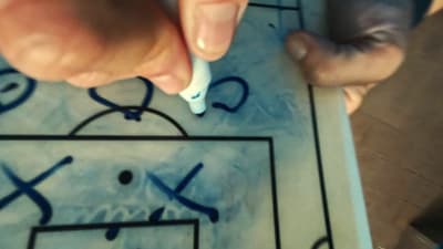 a person is drawing on a sheet of paper