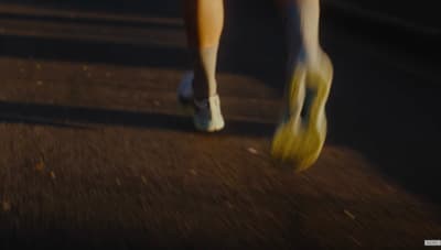 a person walking down a street with yellow shoes