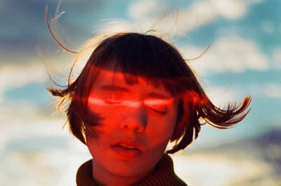 a woman with her hair blowing in the wind
