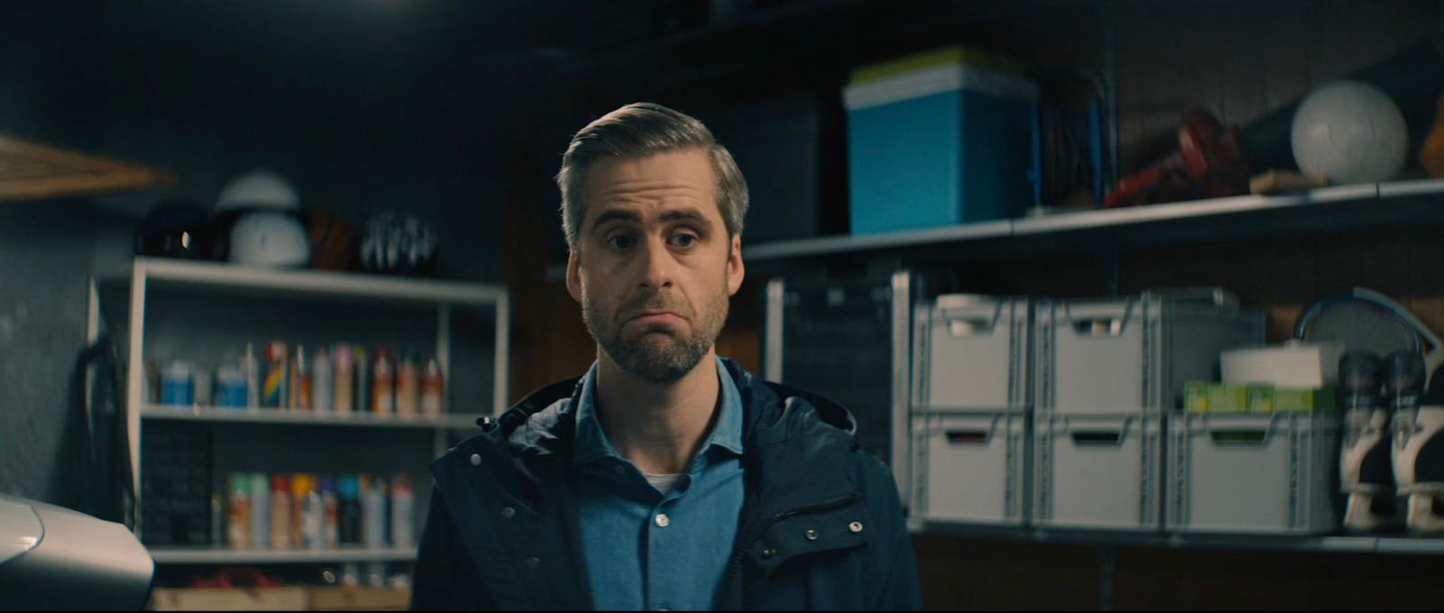 a man standing in front of a book shelf