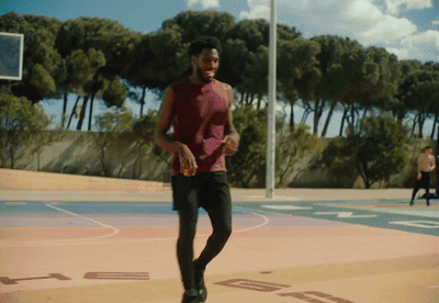 a man in a red shirt is playing basketball
