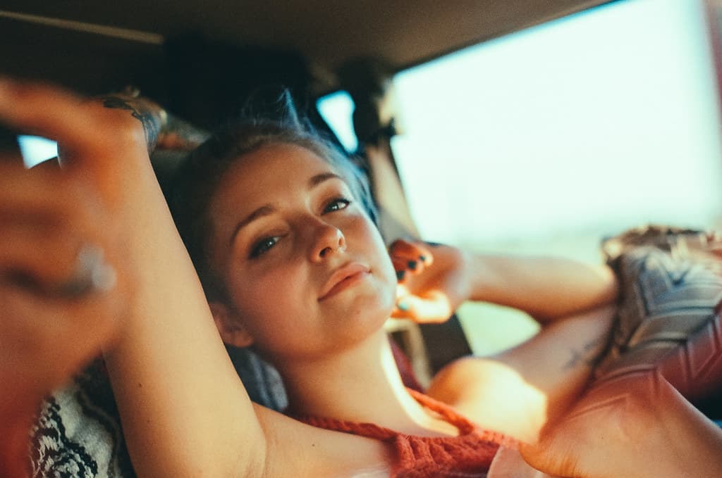 a young girl sitting in the back of a car