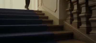 a woman is walking up a set of stairs