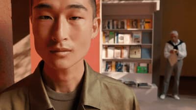 a man standing in front of a book shelf