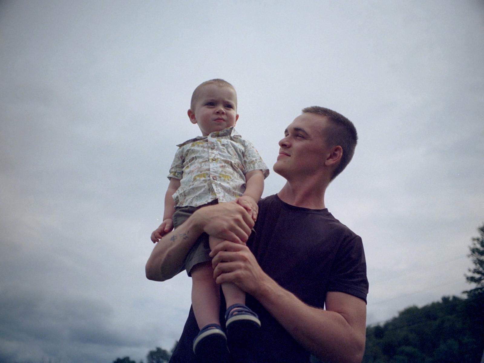 a man holding a small child in his arms