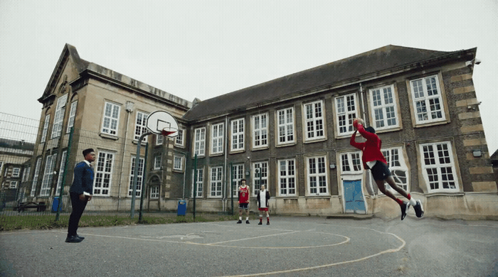 a group of young men playing a game of basketball