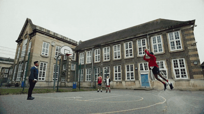 a group of young men playing a game of basketball