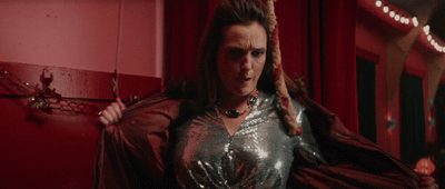 a woman in a silver dress with a long braid