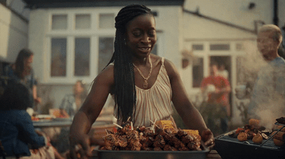 a woman standing in front of a table filled with food