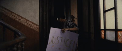 a person holding a sign that says justice