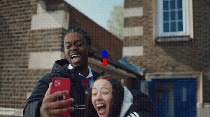 a man taking a picture of a woman laughing