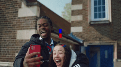 a man taking a picture of a woman laughing
