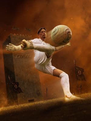 a man kicking a soccer ball on top of a field