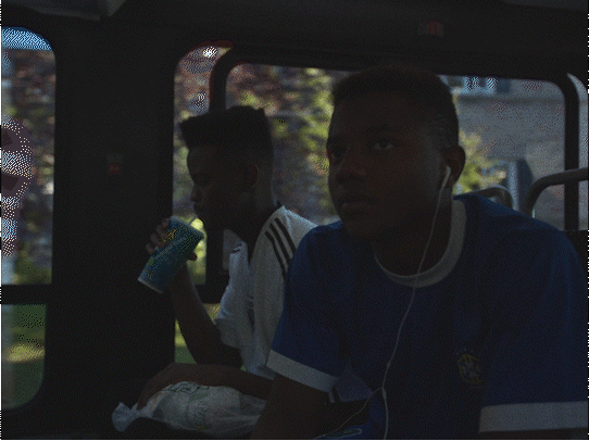 a group of young men riding on the back of a bus