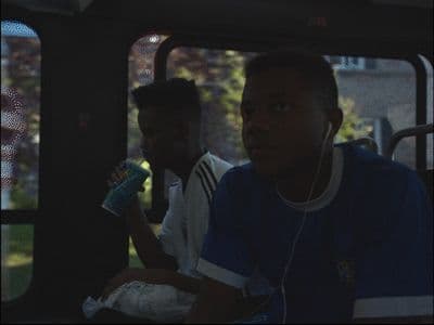 a group of young men riding on the back of a bus