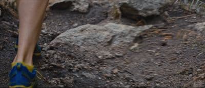 a close up of a person walking on a trail