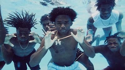 a group of people standing under water in a pool