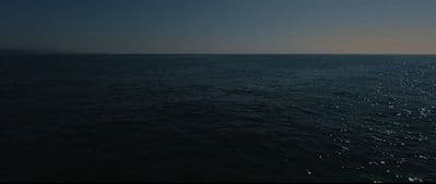 a large body of water under a blue sky