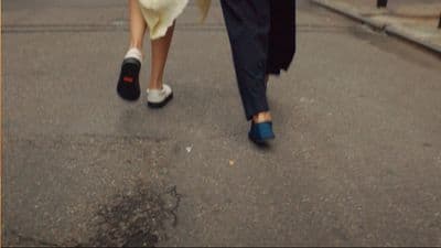 a man and a woman walking down the street