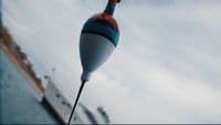 a red, white and blue object hanging from a hook